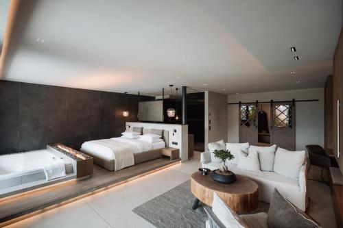 a bedroom with a bed and a living room at Chalet PURMONTES in San Lorenzo di Sebato