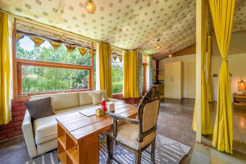 a living room with a couch and a table at Aranya by Stories in Jaipur