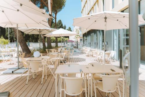 an outdoor seating area with tables and umbrellas at Bikube Montpellier in Montpellier