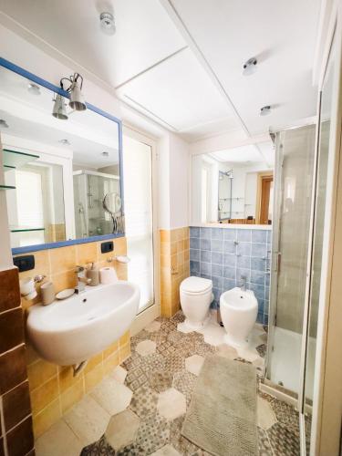 Un baño con lavabo, inodoro y ducha. en San Leone Mare House, en San Leone