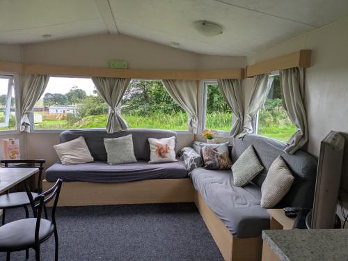 a living room with a couch in a caravan at The Hidden Gem in Galloway Forrest in Balminnoch