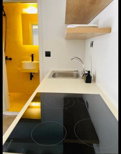 a small kitchen with a sink and a counter top at Fortezzino in Rethymno