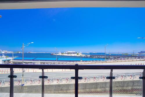 a view from a balcony of a beach and a bridge at UH FLAT The SOKCHO in Sokcho