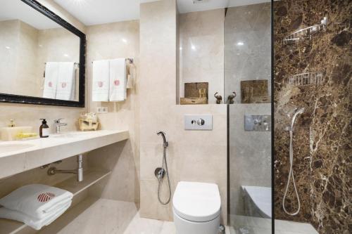 a bathroom with a shower and a toilet and a sink at Apartamento Puerto Portals in Portals Nous