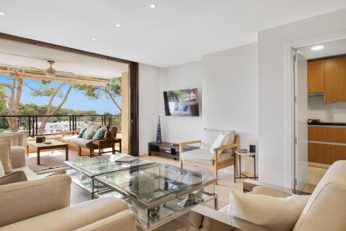 a living room with a glass coffee table at Apartamento Puerto Portals in Portals Nous