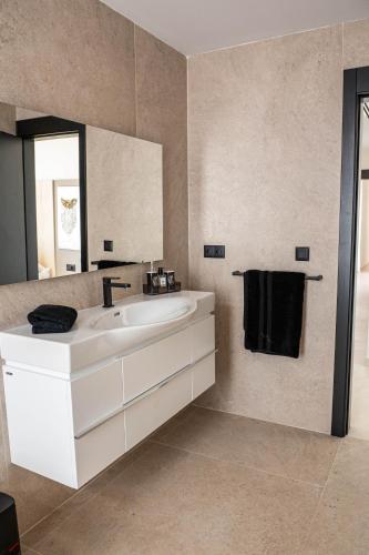 a bathroom with a white sink and a mirror at Villa El Padrino in Callao Salvaje