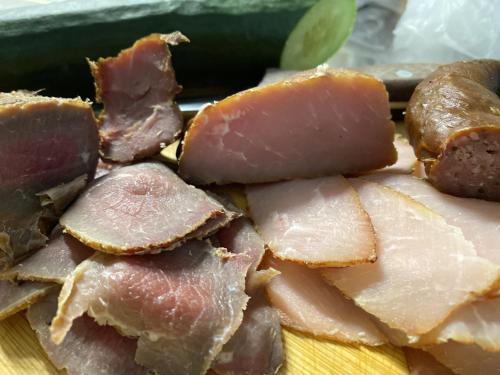 a pile of ham and other food on a plate at Nagelfluhhaus Hirsch in Gunzesried
