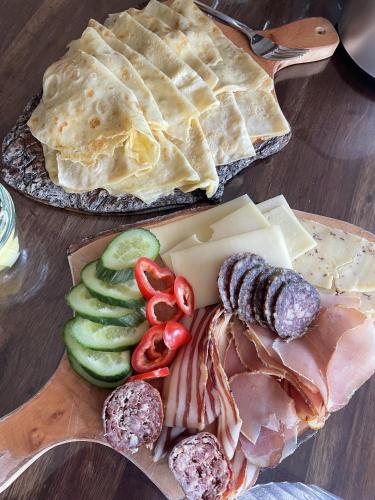 a plate of food with meat and vegetables on a table at Nagelfluhhaus Hirsch in Gunzesried