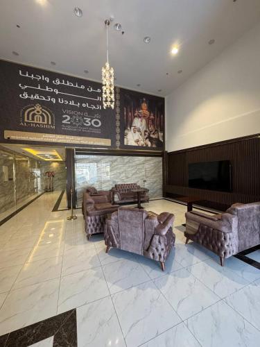a living room with couches and a flat screen tv at سحاب الأندلس للشقق المخدومة 2 أملج Sahab Al Andalus for Served Apartments in Umm Lujj