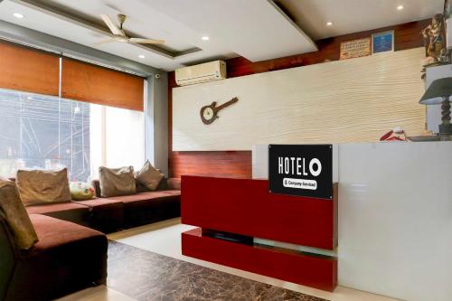a living room with a couch and a tv at Hotel O Railway Station Road Near Clock Tower in Ludhiana