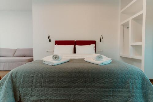 a bedroom with a bed with two towels on it at Ollenia's Harmony Luxury Apartments in Derveni