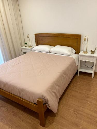 a bedroom with a large bed with a wooden headboard at Casa Santo António in Peso da Régua