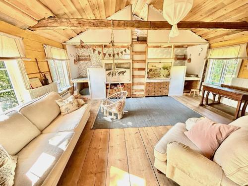 a living room with a couch and a table at Family-friendly countryside house close to lake in Skärås