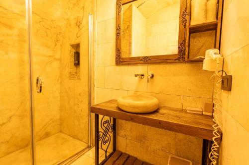 a bathroom with a shower and a toilet on a wooden counter at Walnut House in Goreme
