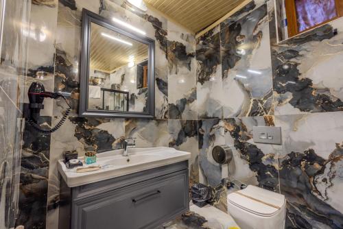 a bathroom with a sink and a toilet at Kayatas Cave Suites in Goreme