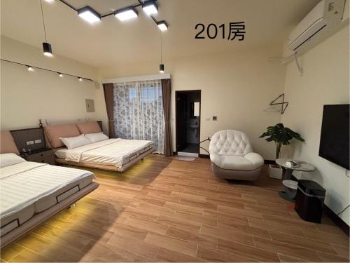 a room with two beds and a couch and a chair at Up villa in Taibao