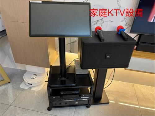 a television on a stand with two video game controllers at Up villa in Taibao