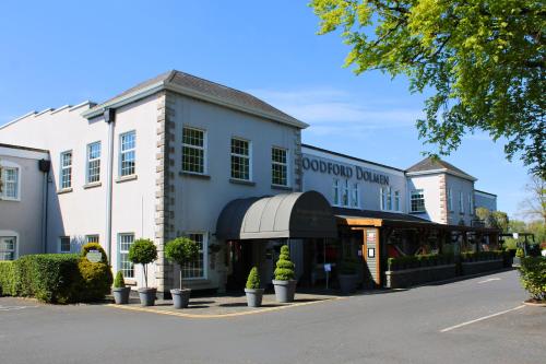 a building with a store on the side of a street at Woodford Dolmen Hotel Carlow in Carlow