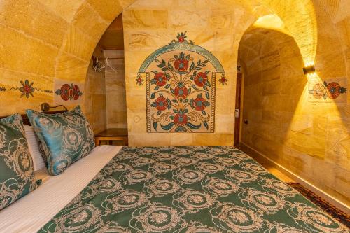 a bedroom with a bed with a pattern on the wall at Walnut House in Goreme