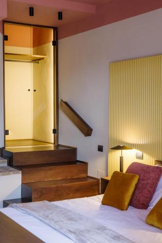 a hotel room with a bed and a staircase at Tenuta San Pietro a pettine in Santa Maria in Valle