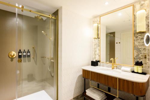 a bathroom with a sink and a shower at Hotel Saski Krakow Curio Collection by Hilton in Kraków