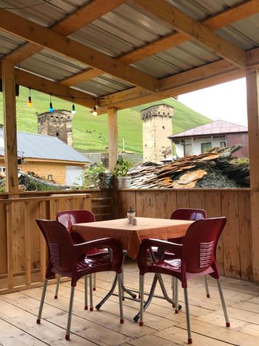 a wooden table and chairs on a patio at Ela in Ushguli