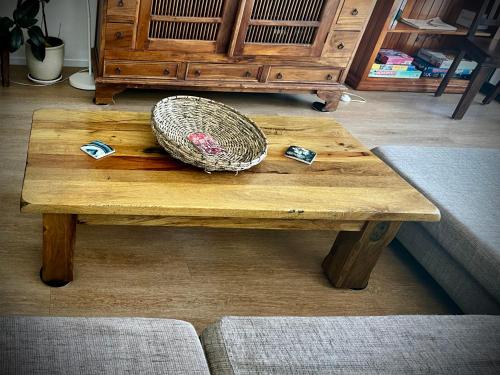 a wooden table with a hat on top of it at Casual comfort in Byron Shire in Mullumbimby