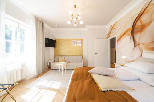 a living room with a bed and a couch at Golden Flat by GrazRentals with parkview - brandnew & free parking in Graz