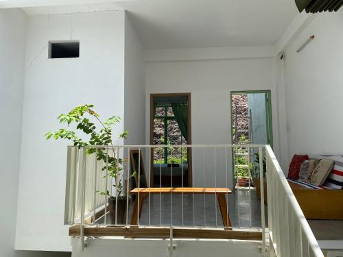 a room with a staircase with a table and a couch at Tiny cozy house in Danang
