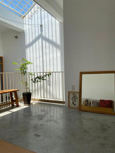 a large room with a large window and a framed picture at Tiny cozy house in Danang
