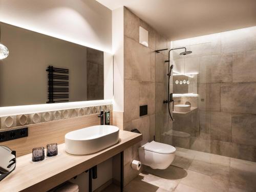 施瓦茨Schlosshotel Mitterhart的带水槽、马桶和淋浴的浴室