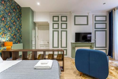 une chambre avec une table et une chaise bleue dans l'établissement Childebert - Furnished apartment - Downtown Lyon, à Lyon