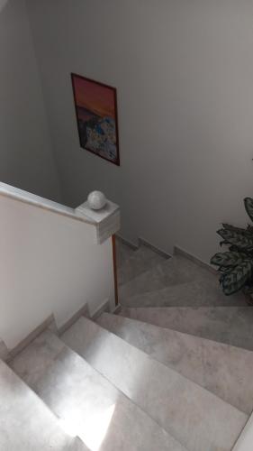 a room with white walls and a painting on the wall at Apartments Zafiria in Ágios Konstantínos