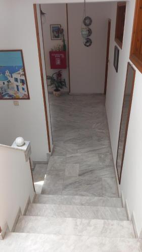 a stairway with a tile floor in a house at Apartments Zafiria in Ágios Konstantínos
