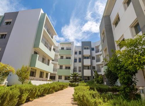 アル・ジャディーダにあるLuxueux appartement neuf,sécurisée, piscine, Wi-FI, Pool et parkingの通路のある高層アパートの列