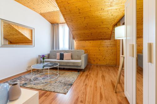 a living room with a couch and a table at Hotel Rozálka in Pezinok