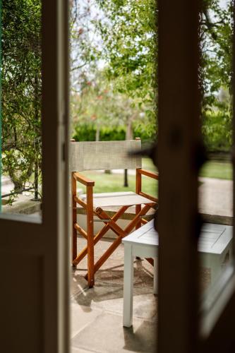 a wooden bench sitting on a patio outside a door at Tenuta Centoporte in Otranto
