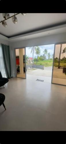 a room with an open door with a view of a house at Oia in Moalboal