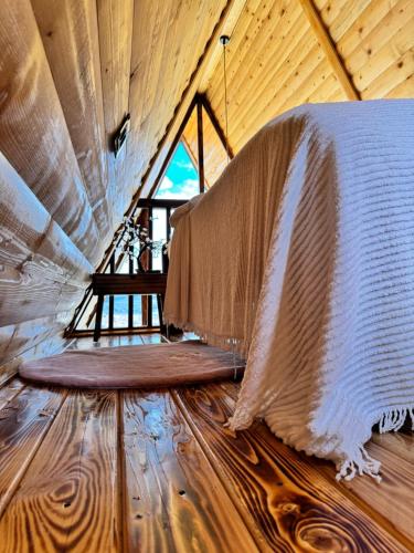 a room with a curtain on a wooden floor at Cozy Cabin House in Novi Pazar