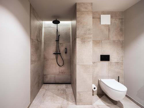 a bathroom with a shower with a toilet and a sink at Schlosshotel Mitterhart in Schwaz