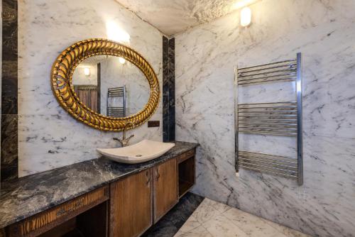 a bathroom with a sink and a mirror at Kayatas Cave Suites in Goreme