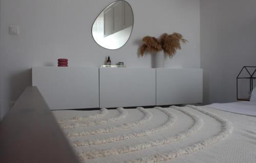 a white room with a circular mirror and a rug at Family Dream Dalmatia - Split by Villas Guide in Košute