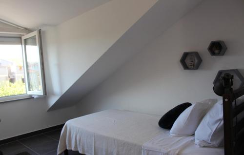 a white room with a bed with a window at Family Dream Dalmatia - Split by Villas Guide in Košute