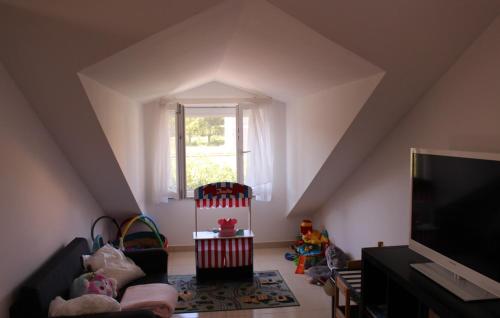 a attic room with a couch and a window at Family Dream Dalmatia - Split by Villas Guide in Košute