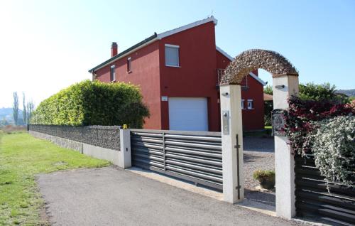 a fence in front of a red house at Family Dream Dalmatia - Split by Villas Guide in Košute