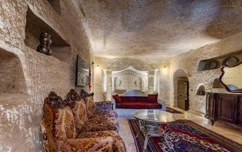 a living room with a couch and a table at Kayatas Cave Suites in Goreme