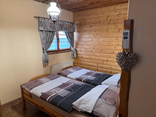 a bedroom with two beds and a window at Steak Restaurant Penzion Country Saloon in Klatovy