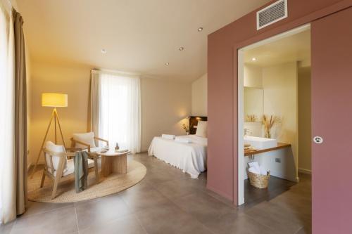 a hotel room with a bed and a desk and a mirror at Casa Marcial (adults only) in Besalú