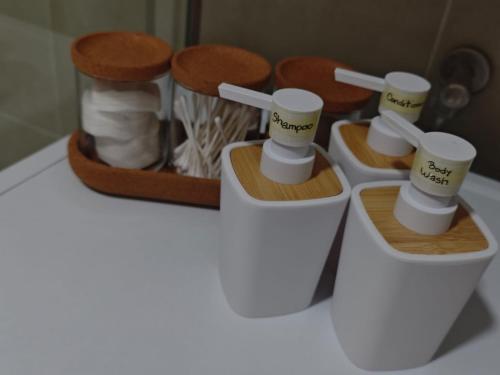 a bathroom with three toilets and a box of towels at Lux apartment airport in Ledine