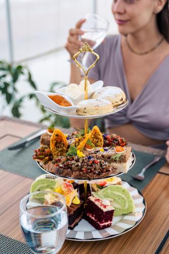 a woman sitting at a table with a plate of food at Bolagala Agro Floating Resort in Negombo